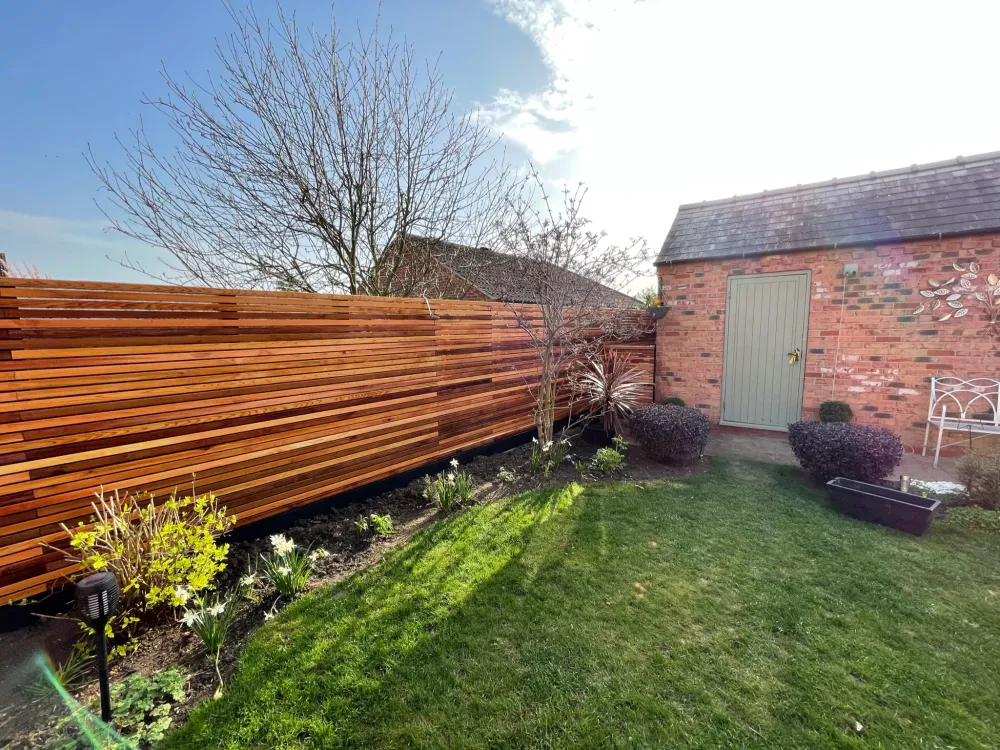 Completed landscaping project — modern slatted timber fence installation
